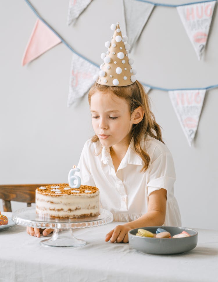 A Girl Blowing A Candle 