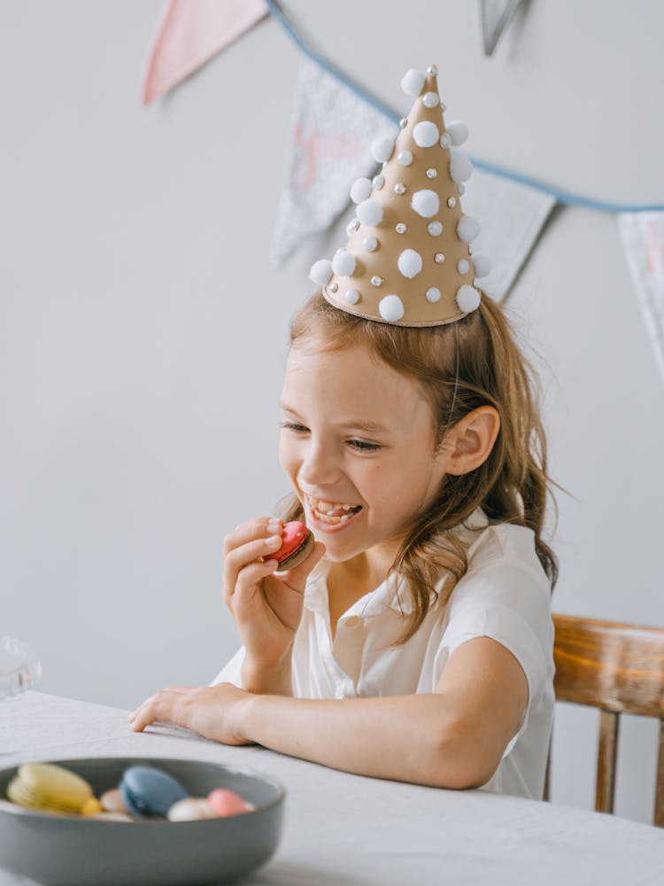 A Young Girl Eating French Macarons