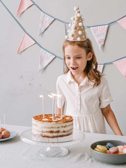 Free A Young Girl Looking at her Birthday Cake Stock Photo