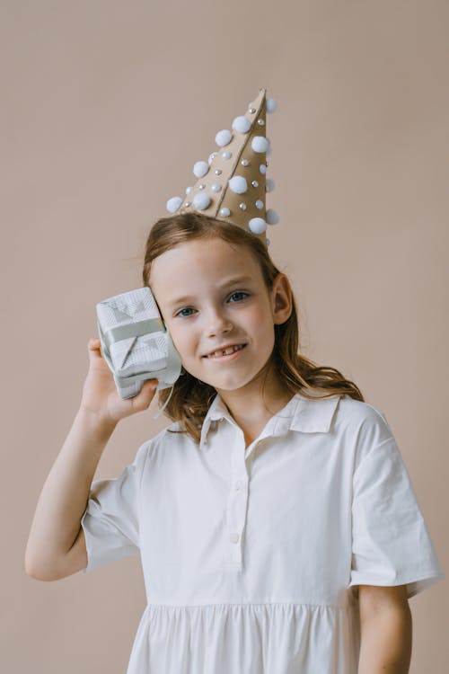 A Young Girl Smiling while Holding Her Present