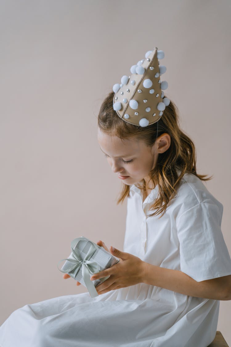 A Girl Holding A Birthday Present 