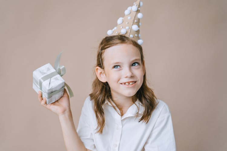  A Girl Holding A Gift 