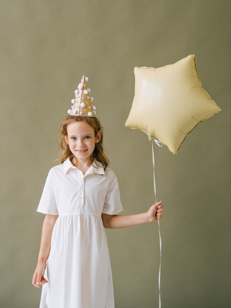 A Birthday Girl Holding A Balloon