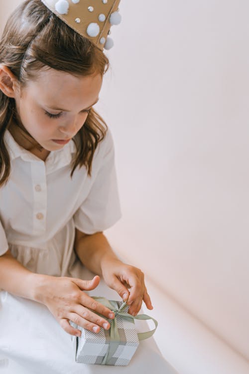 Free A Girl Opening a Present  Stock Photo