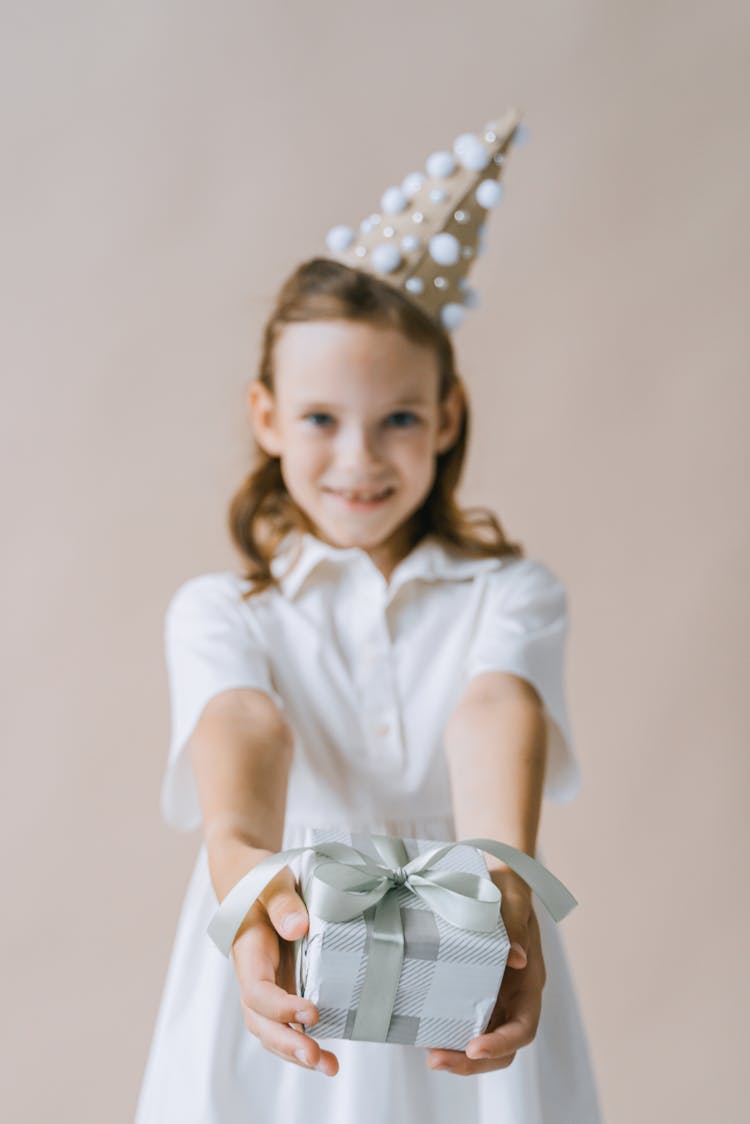 A Birthday Girl Holding A Gift