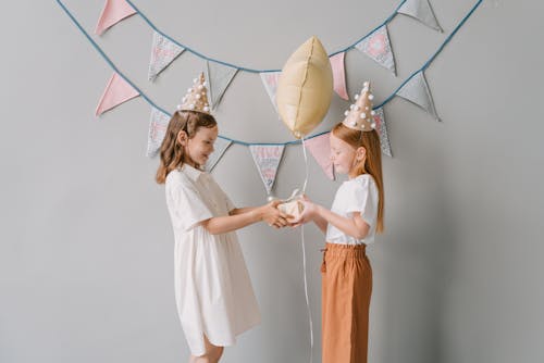 Free A Girl Giving a Gift to a Birthday Celebrant Stock Photo