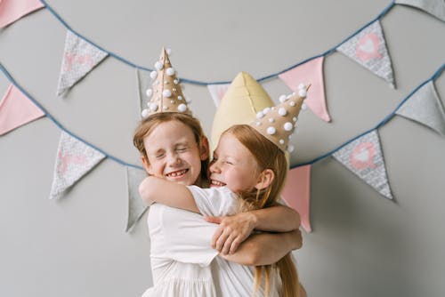 Young Girls Smiling while Embracing each other