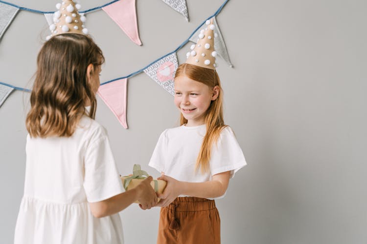 Girl Giving Gift To Her Friend 