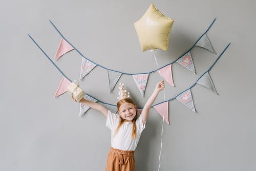 Free Photograph of a Girl Holding a Box and a Balloon Stock Photo