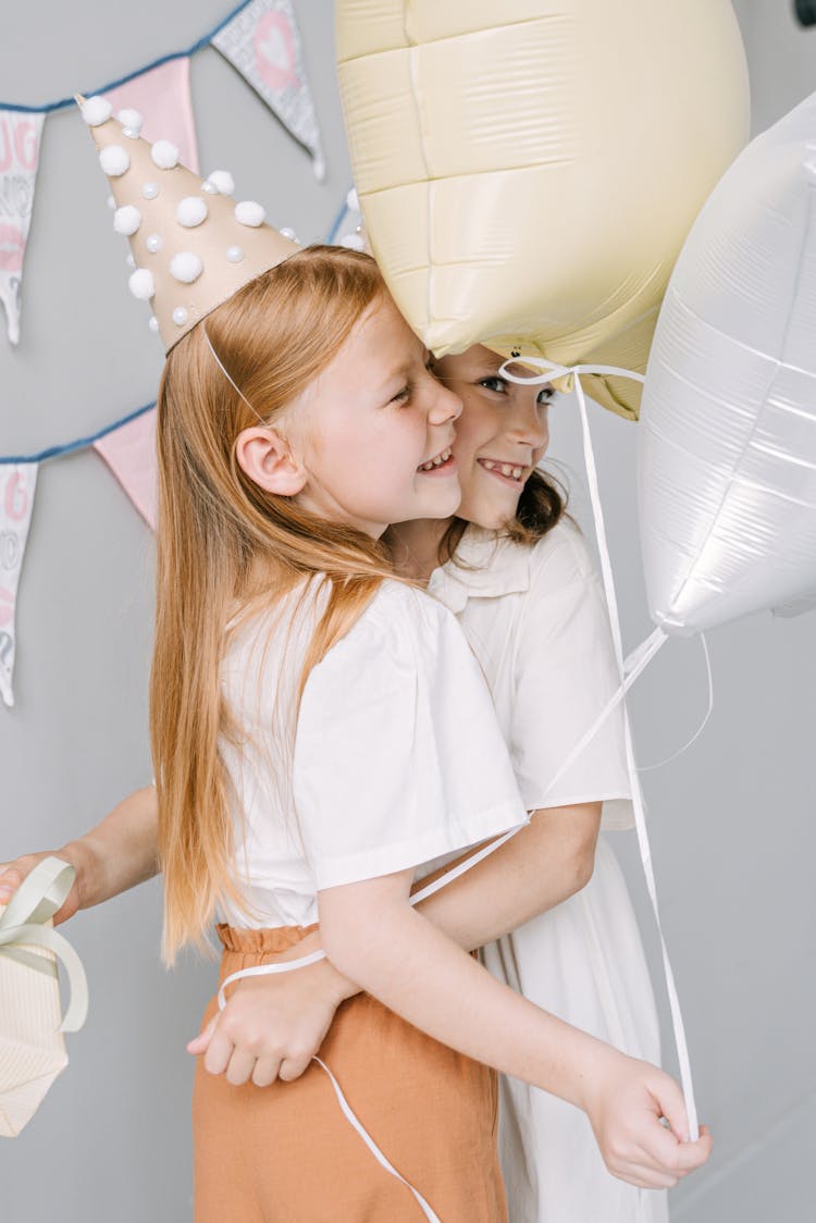 Photo Of Kids With Balloons Hugging