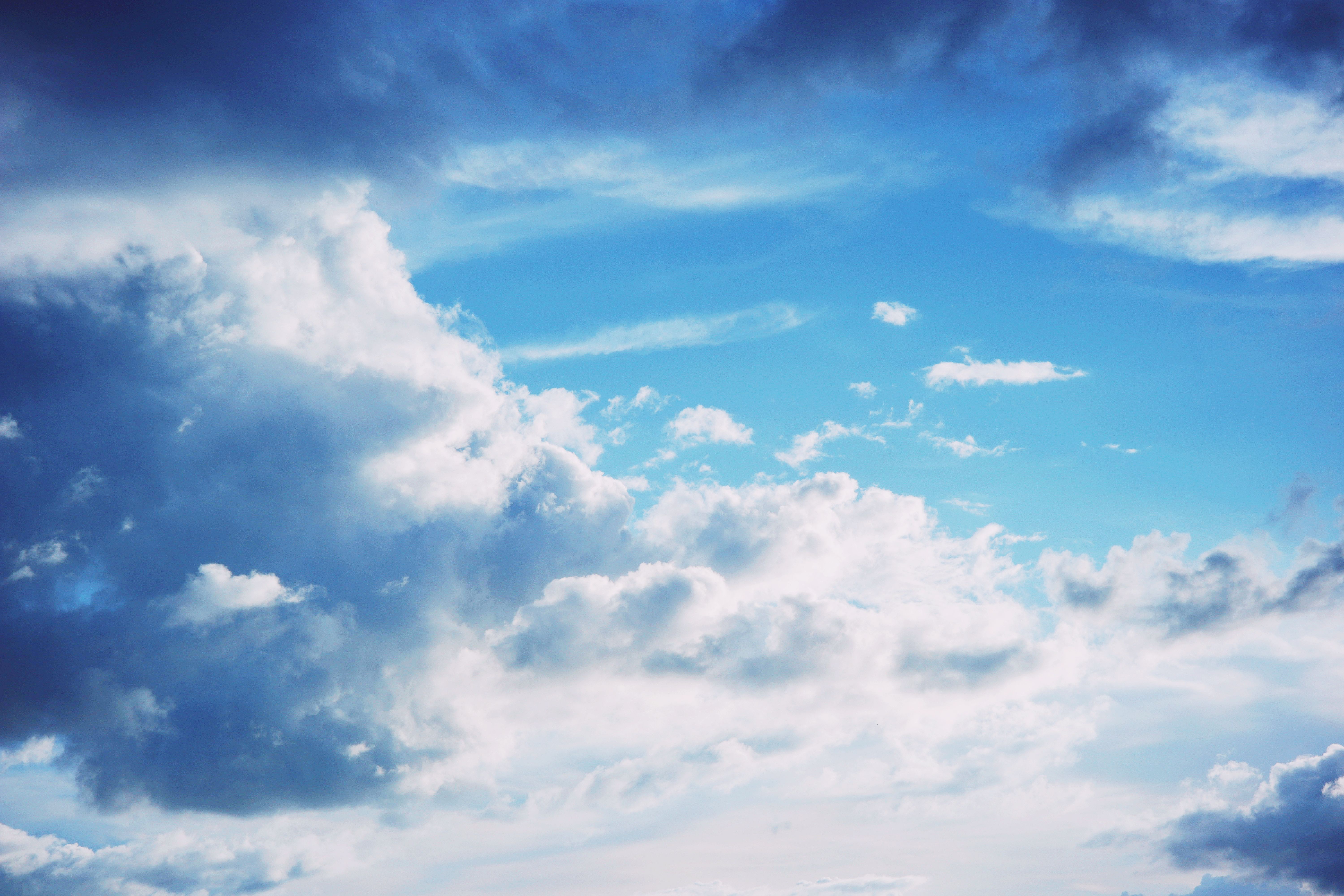 A stunning view of a bright blue sky filled with fluffy clouds, capturing a serene and peaceful atmosphere.