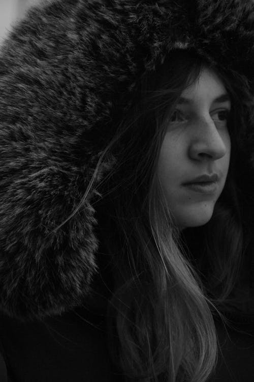 Grayscale Photo of Woman Wearing Fur Coat