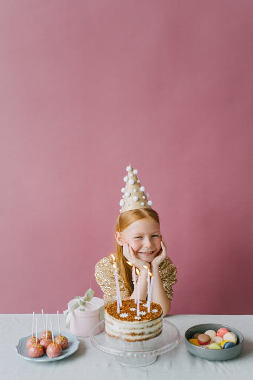 Free Happy Girl in Gold Dress Celebrating Her Birthday Stock Photo