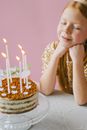 Girl Wishing Over Birthday Cake