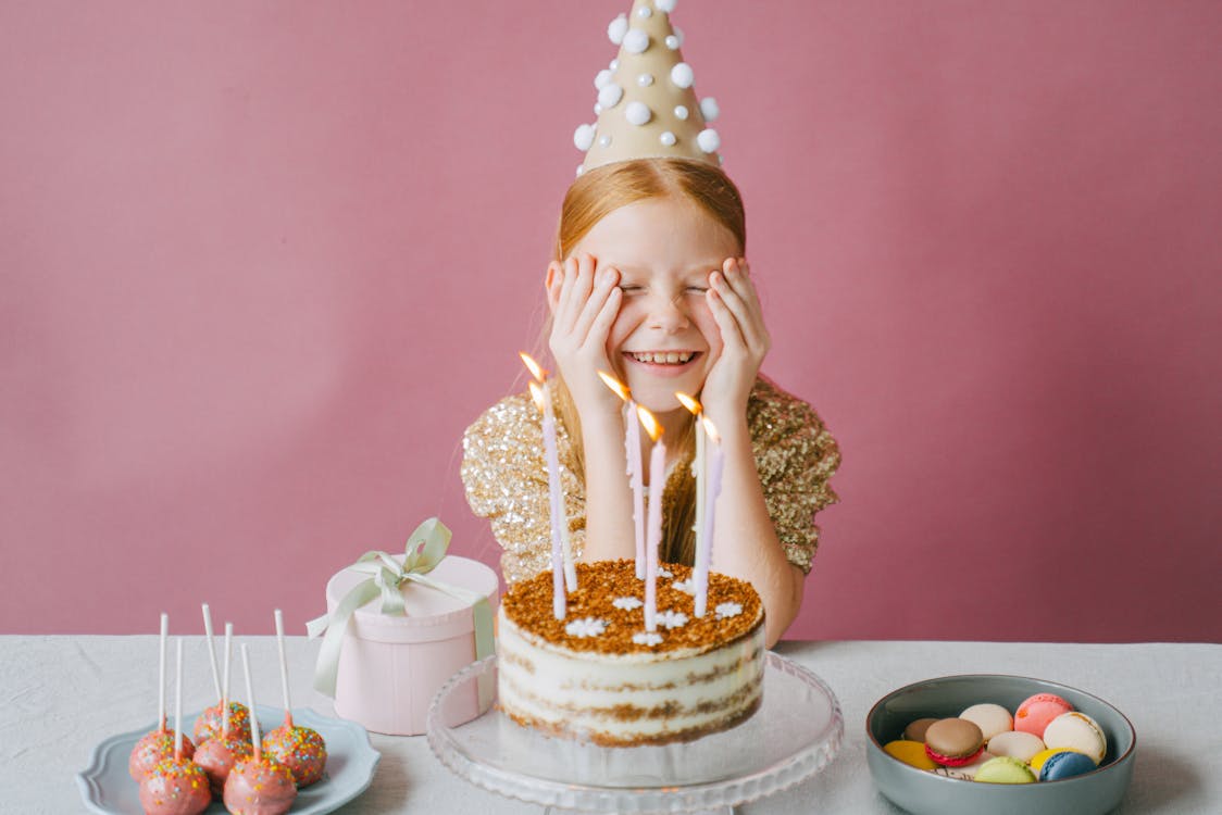 Free Happy Girl in Gold Dress Celebrating Her Birthday Stock Photo