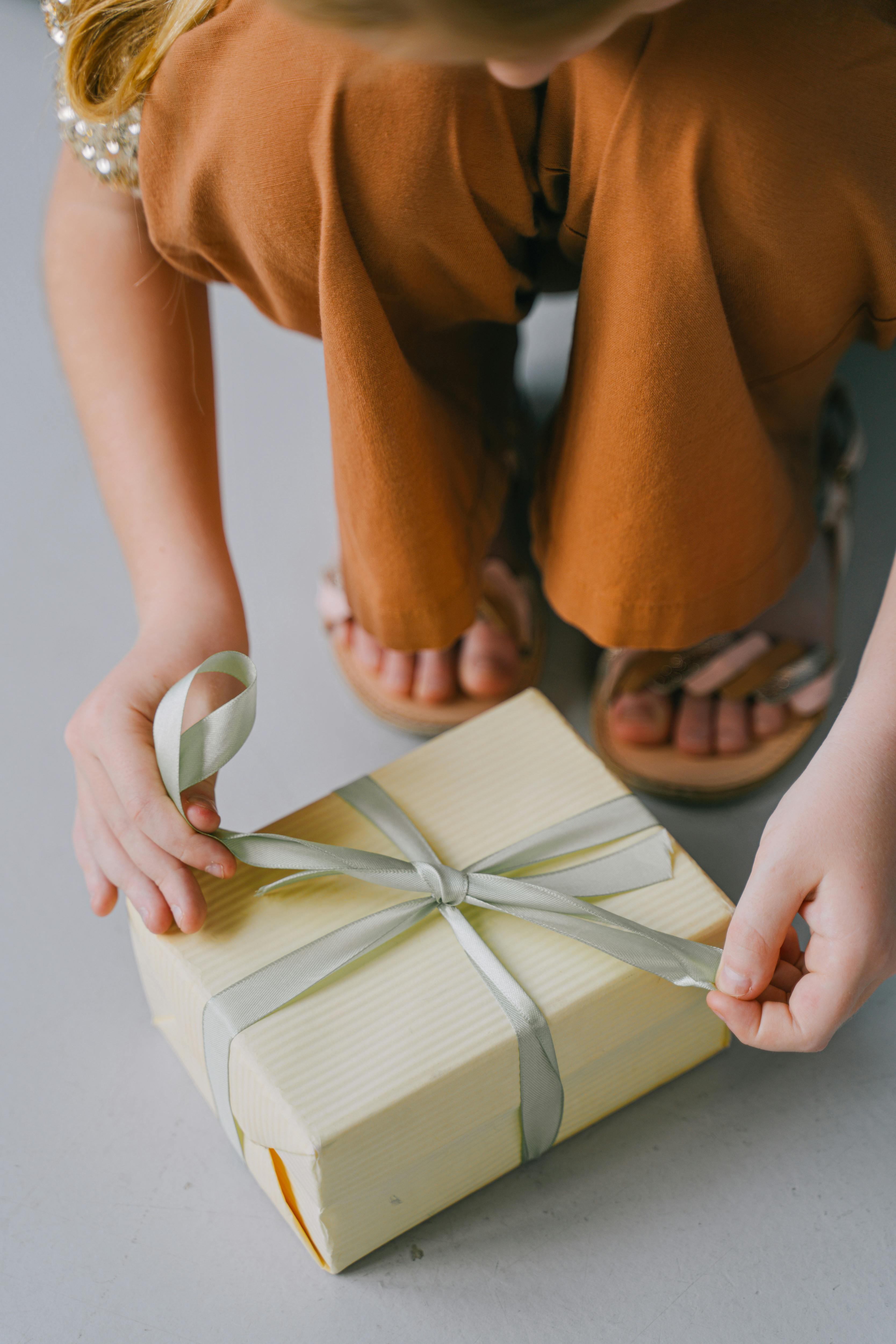 Close up of Woman Tying Box with Ribbon · Free Stock Photo