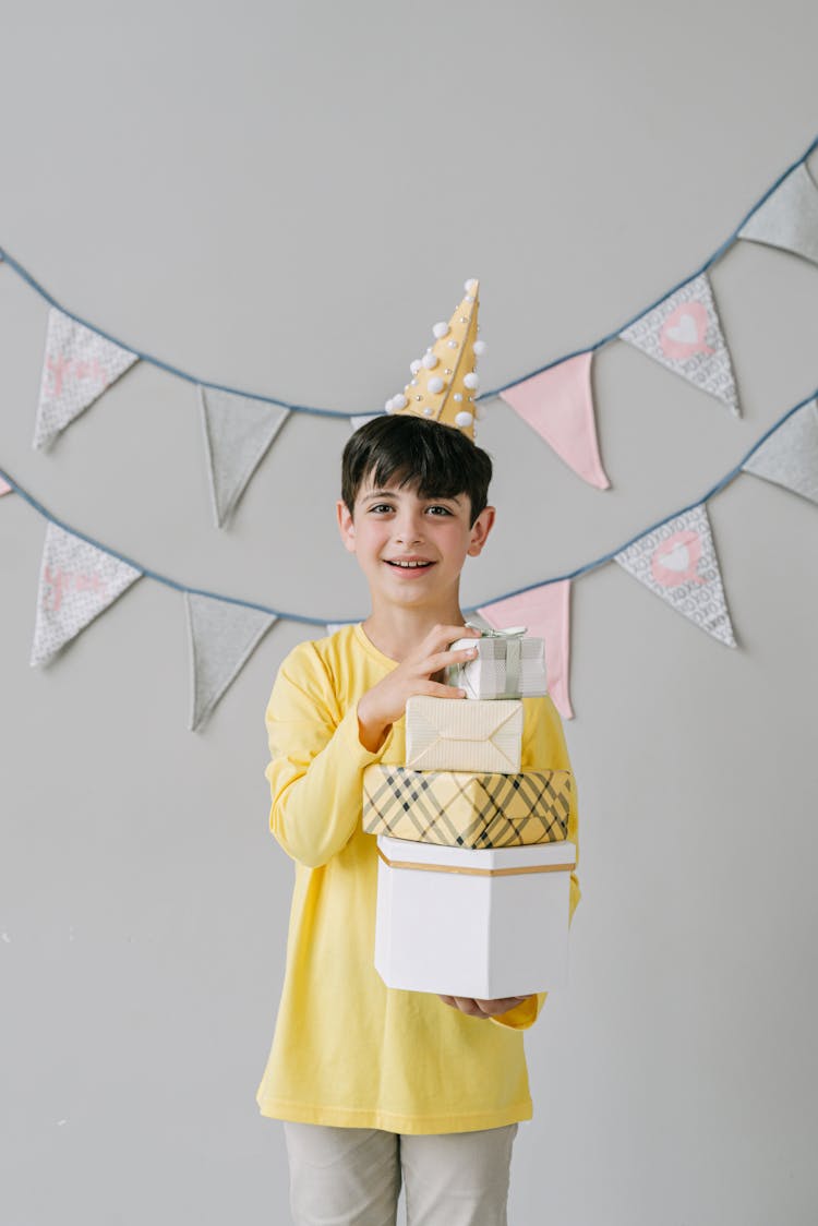 A Birthday Boy Holding Gifts