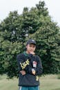 Man in Black Hoodie Wearing Black Cap