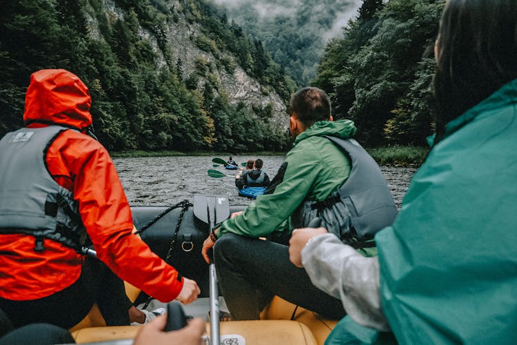 People In Boats Rafting On Mountain River