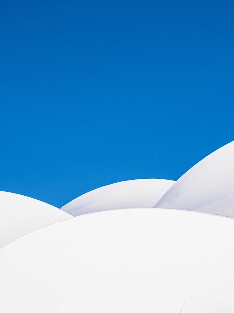 White Balloons Against Blue Sky