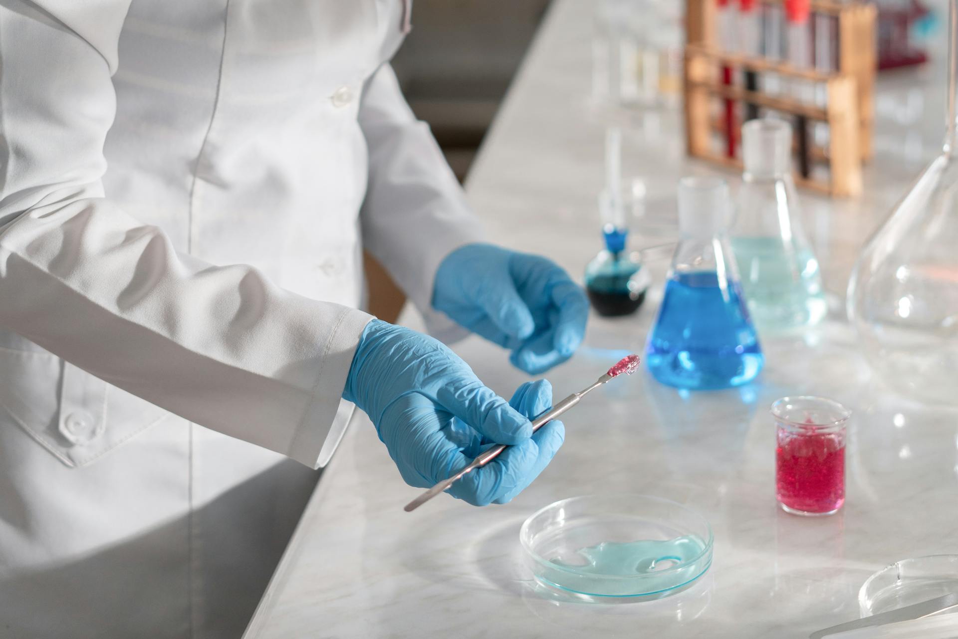 A Person in White Long Sleeve Shirt Wearing Blue Medical Gloves