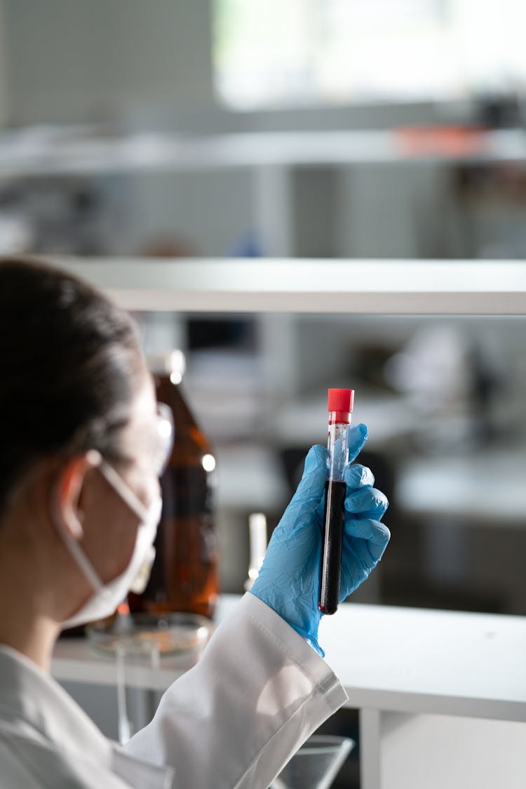 A Female Doctor Holding A Test Tube