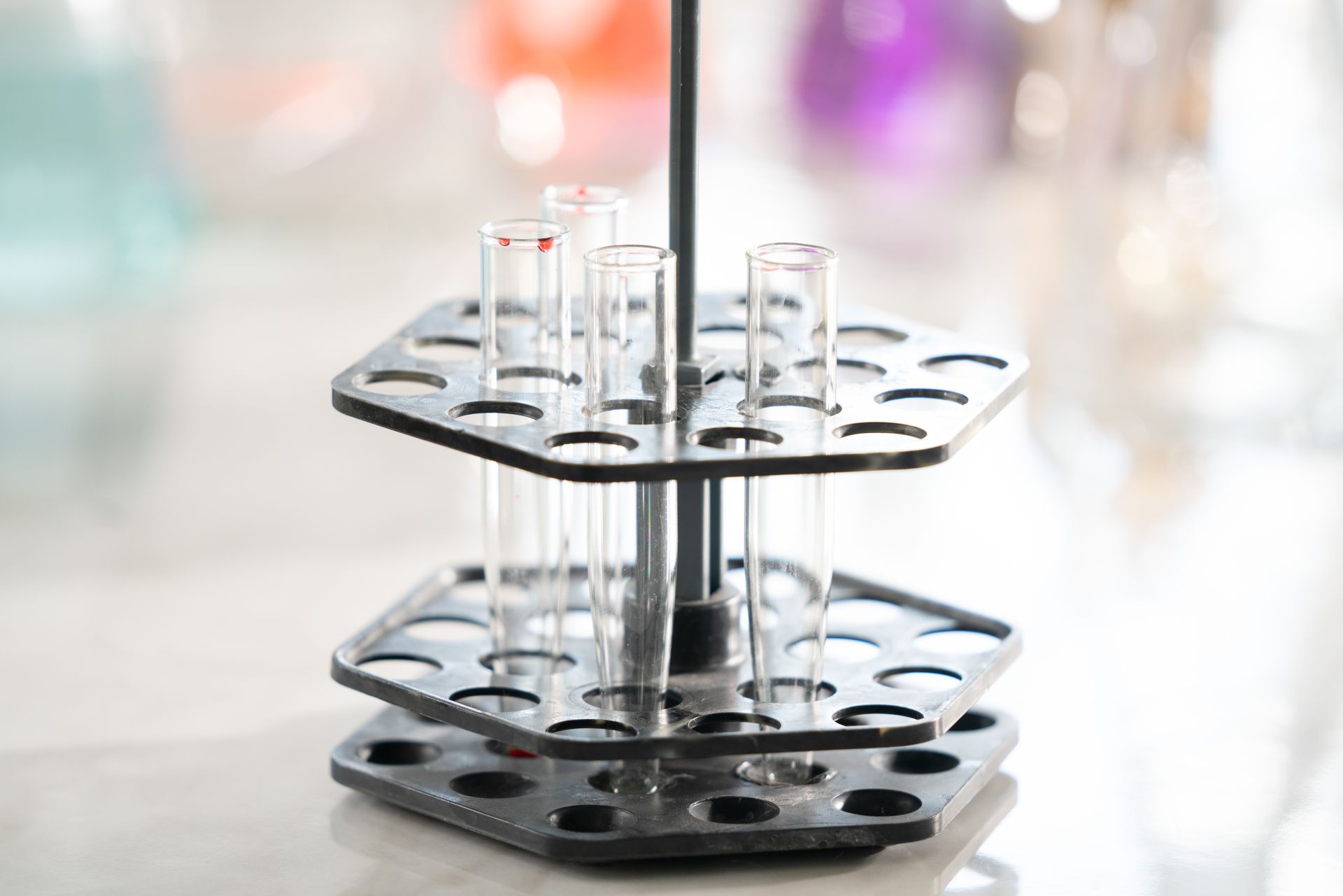 Focused shot of empty test tubes in a lab holder, symbolizing scientific research.