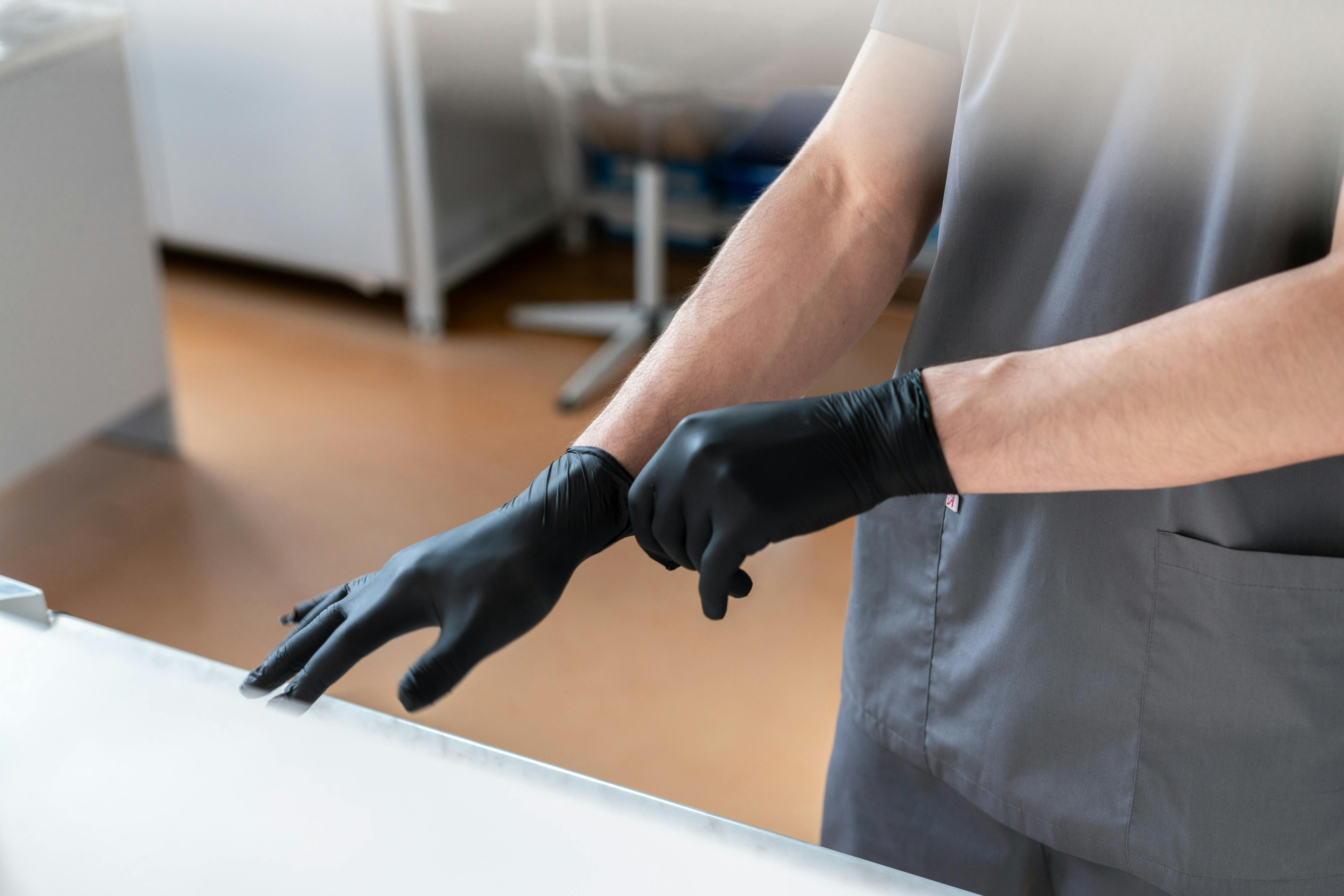 Scientist wearing gloves in a laboratory setting, emphasizing safety and precision.