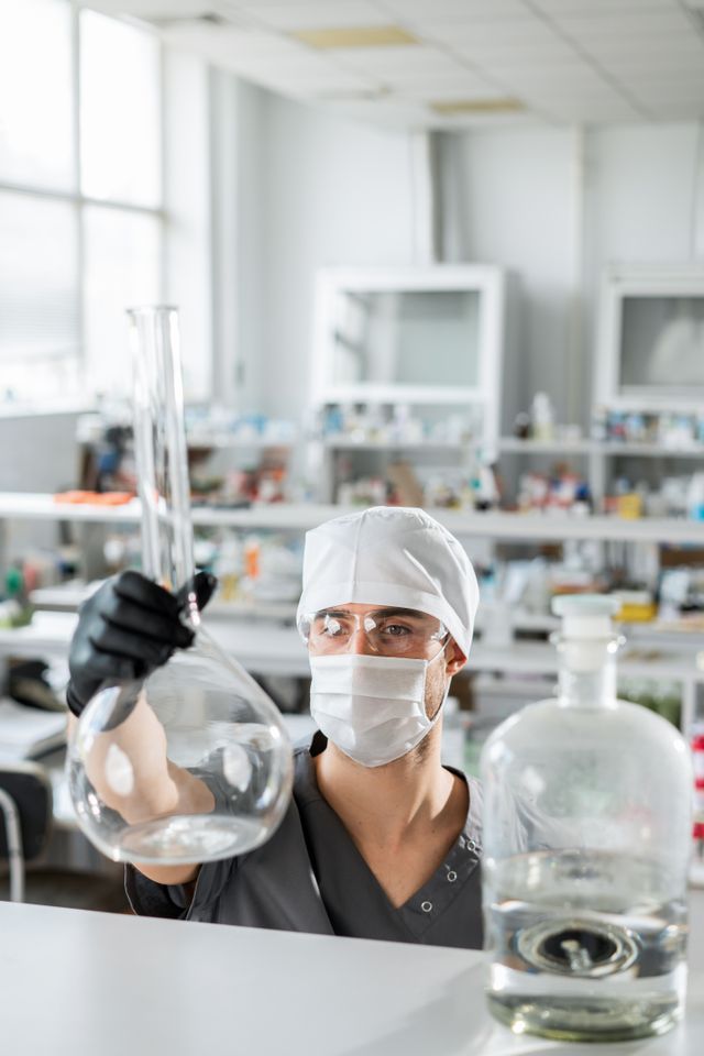 A scientist working with glassware in a laboratory