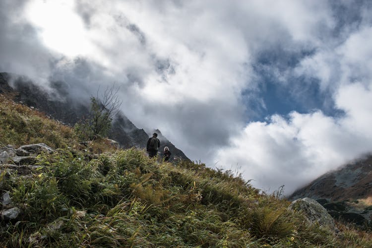 Man And Woman On Mountain Grass