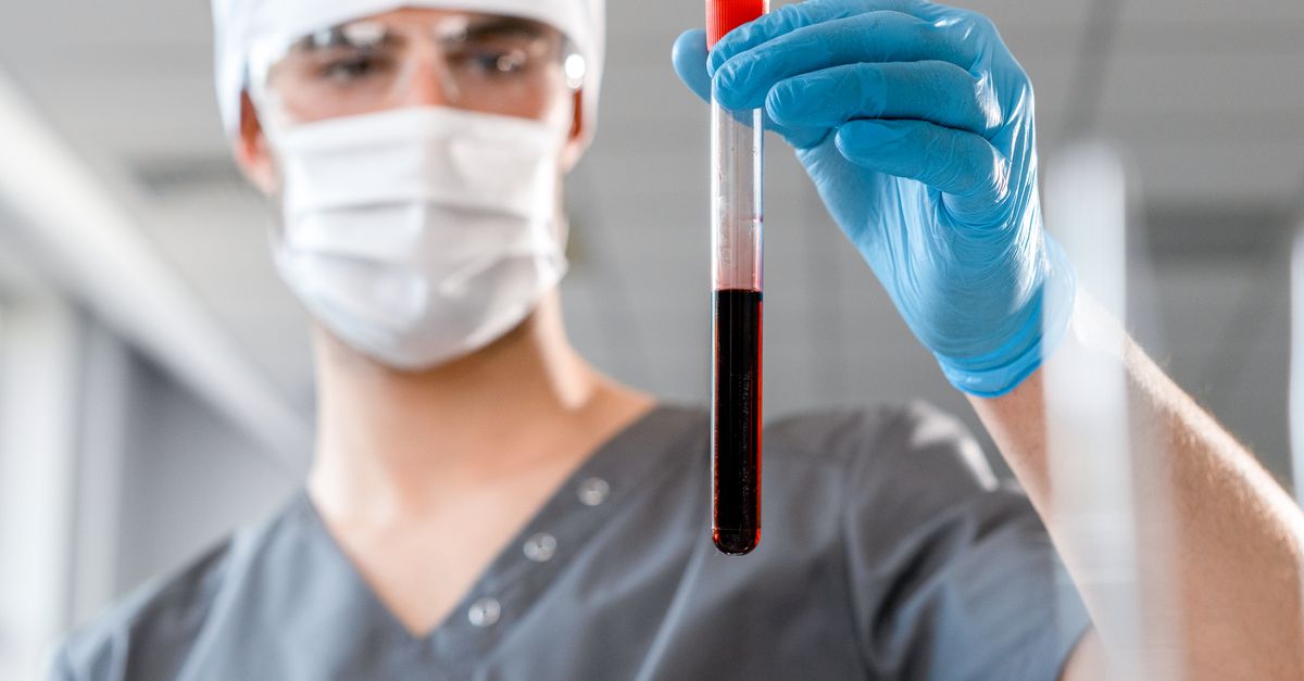 Doctor examining a blood sample in a laboratory setting, showcasing medical research. - Evidence evidence guide for beetroot blood flow meta-analysis