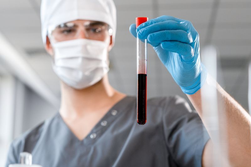 A clinician checking a blood sample delivered to the hospital lab — photo by Ivan S on Pexels