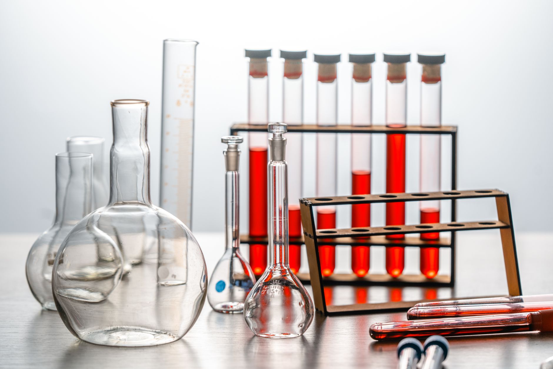 Close-up of various lab glassware with red liquids, ideal for scientific or educational use.