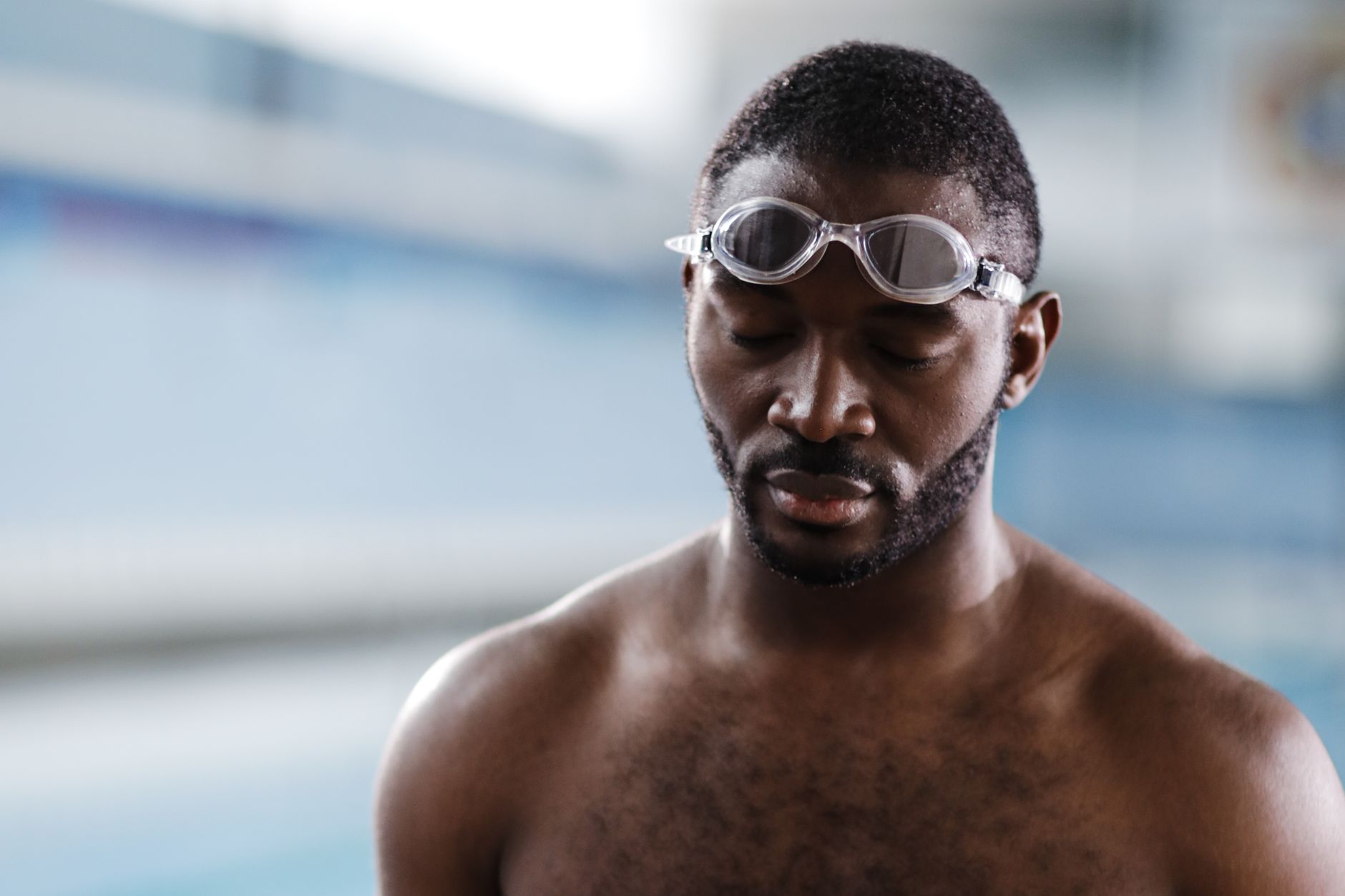 Open water swimmer wearing goggles during a low-light dawn swim