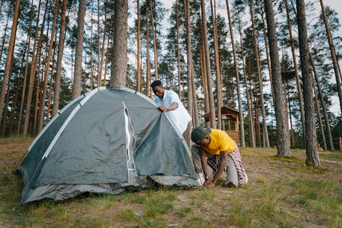 Free Men Setting Up a Camping Tent Stock Photo