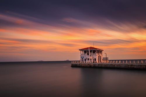 Free A serene sunset over Moda Pier in İstanbul, featuring a vibrant sky and calm sea. Stock Photo