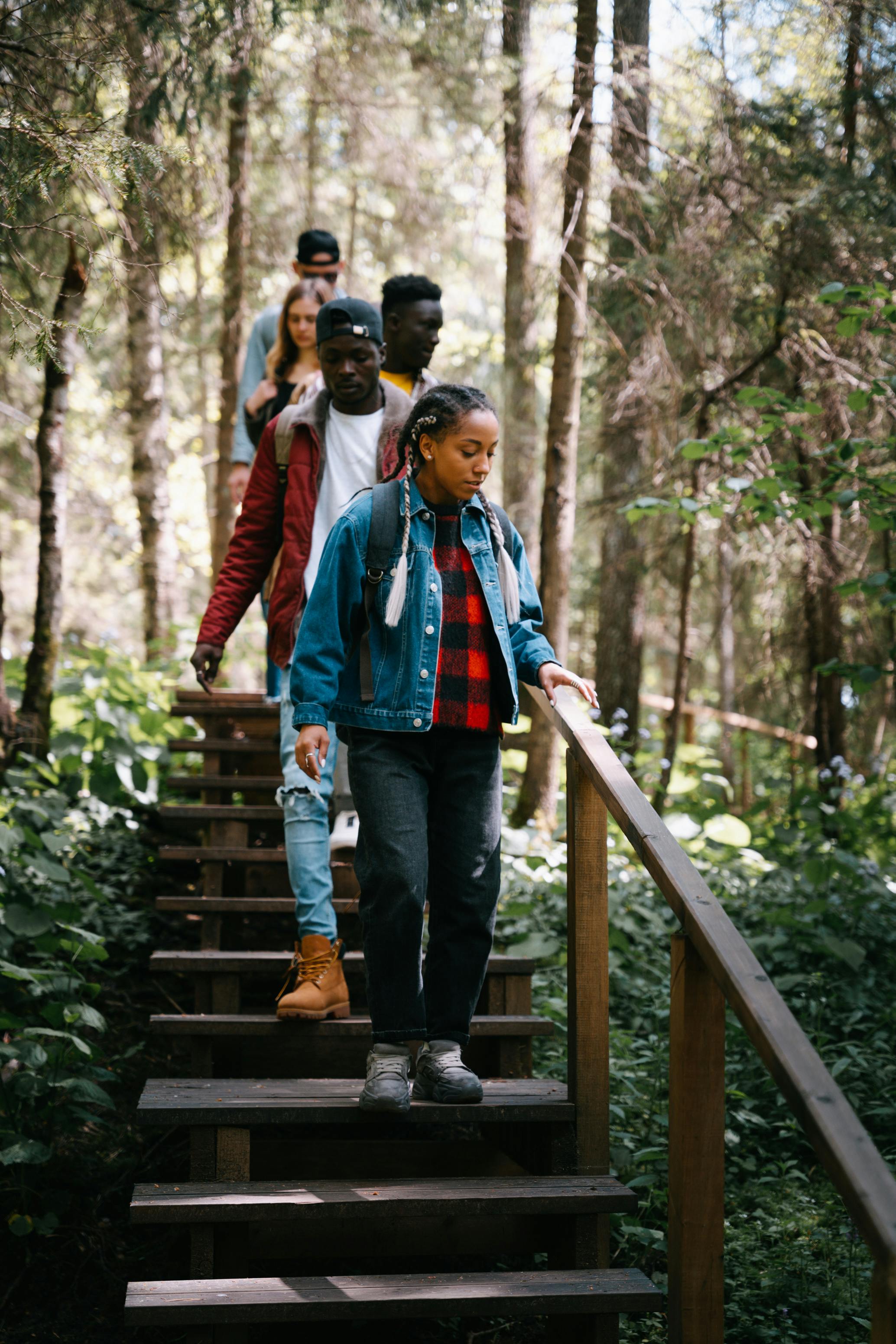 group of people going down on wooden stairs