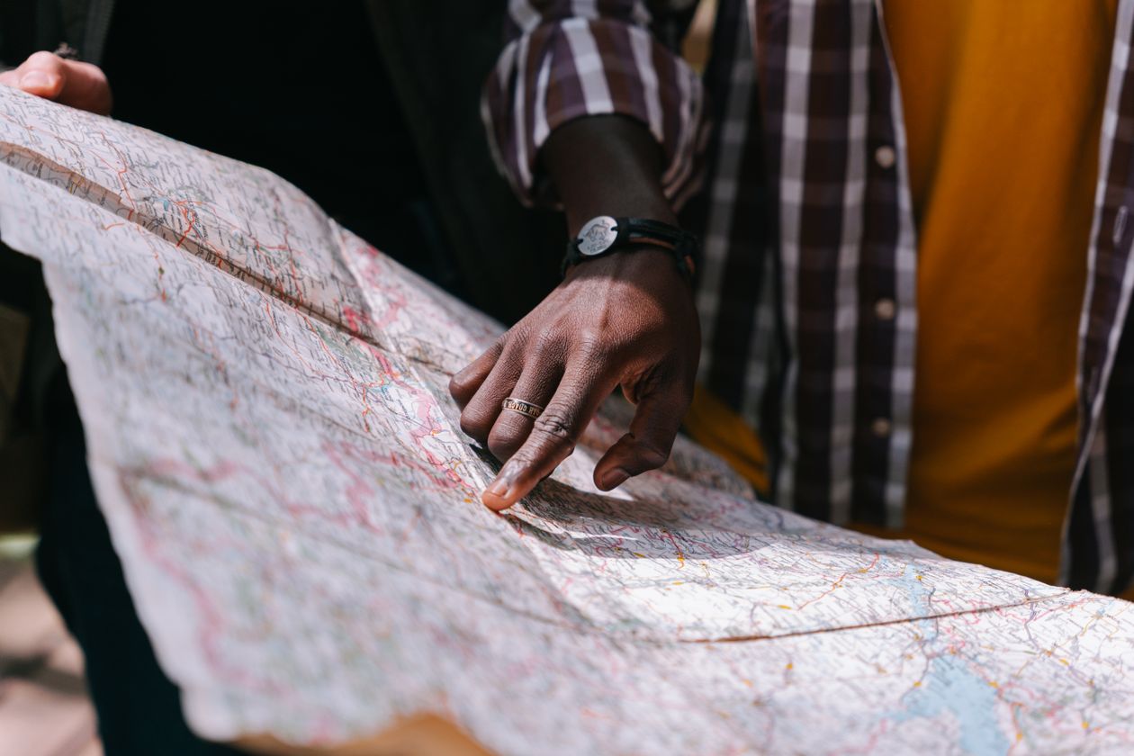 Hand pointing at a detailed map