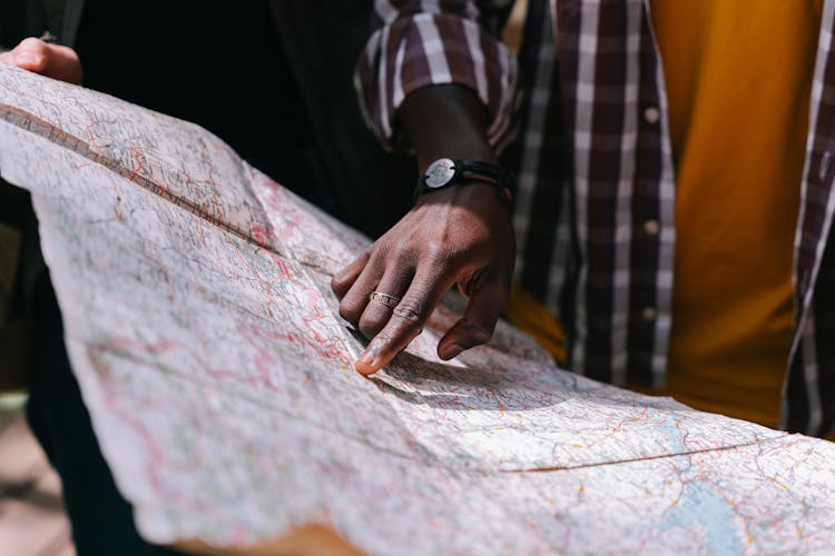 A Person Pointing A Map