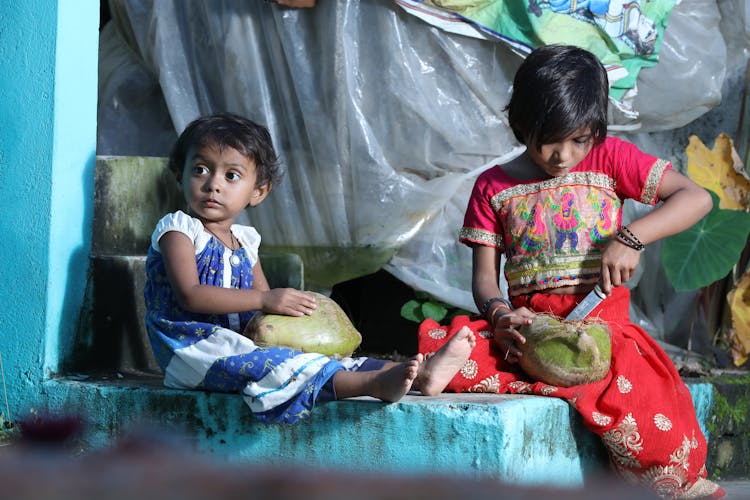 Young Girls Holding Coconut Fruits