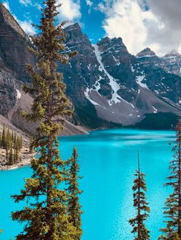 Experience the serene beauty of Moraine Lake with turquoise waters and majestic mountains.