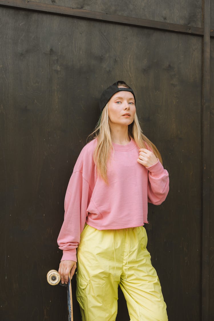 A Woman In Pink Sweater And Yellow Pants