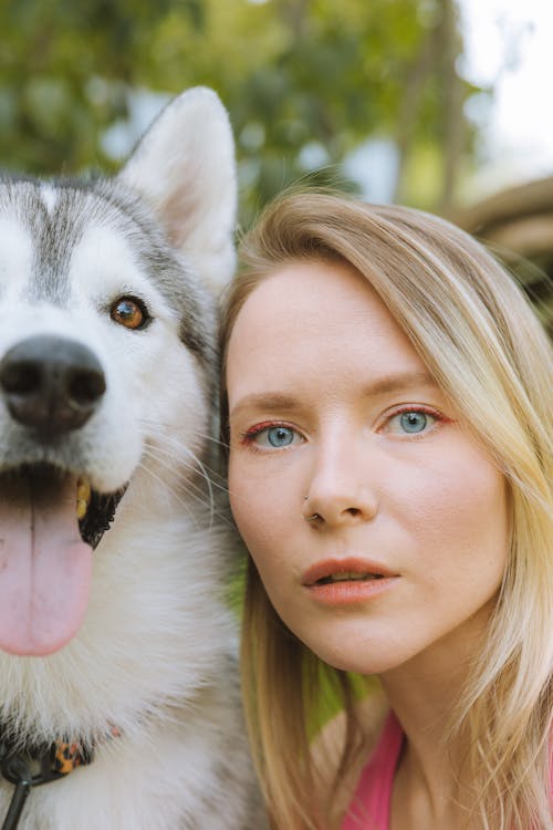 Free A Woman with Her Cute Husky Dog Stock Photo