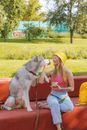 A Woman Feeding Her Dog