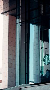 Refined view of modern architecture featuring a café with a glass facade in an urban setting.