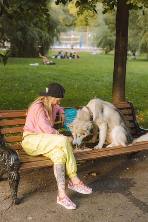 Free A Woman with Her Dog in the Park Stock Photo