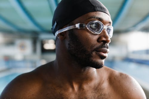 Man Wearing Googles and Black Swim Cap in Close Up Photography