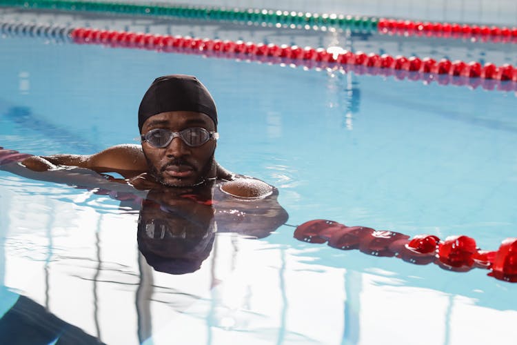 Man Swimming With Goggles In The Pool