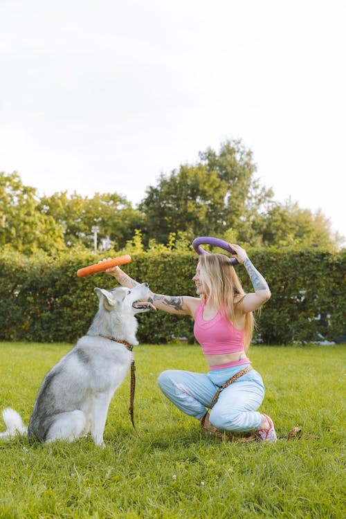 Free Woman Playing with Her Siberian Husky Pet Stock Photo