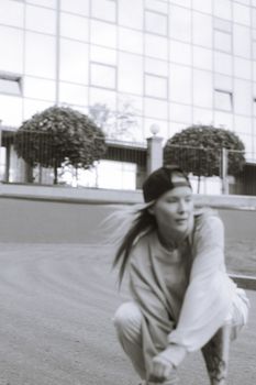 Black and white image of a young skater in action, capturing a modern urban feel.